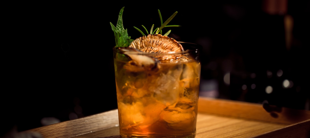 clear glass tumbler on brown wooden tray